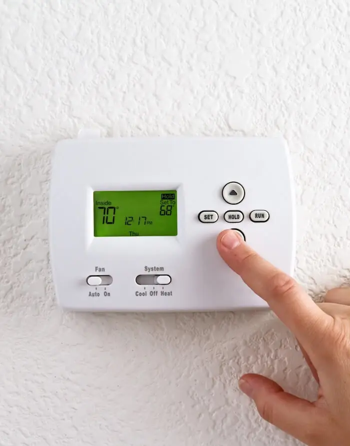 digital thermostat with finger pressing button