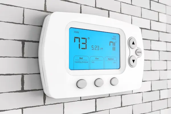 Digital home thermostat on wall